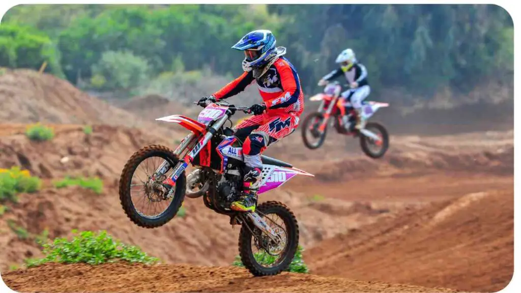 two motocross riders in action on a dirt track