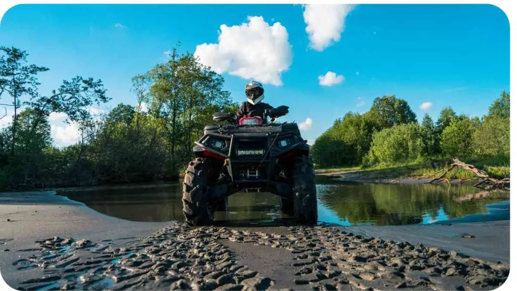 a person on a four wheeler ATV in the mud